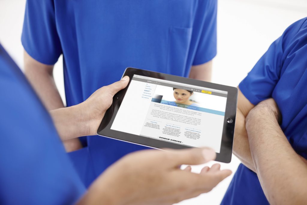 Technicians holding an iPad displaying the oneSOURCE website